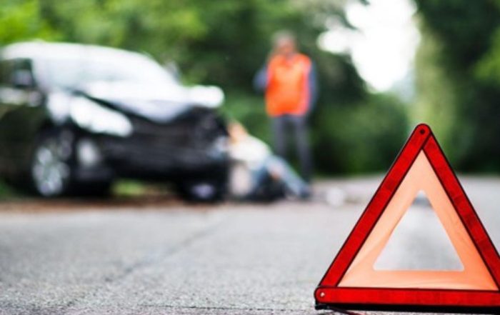 Damaged vehicle stopped after striking a road hazard while a personal injury attorney reviews liability options with the driver | Who Is Liable if a Road Hazard Causes a Car Accident?